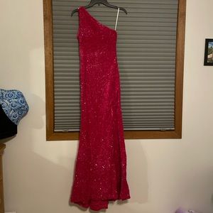 This dress is a Size 4 Pink sparkly prom dress with a slit in the leg.